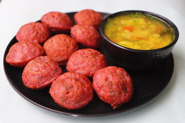 Beet root Appum or Appe, Appam or Mixed dal or Rava Appe served with sambar, south Indian food