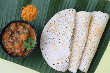 Set dosa served with black chana curry and podi, or sponge dosa, thick fluffy and soft made with...