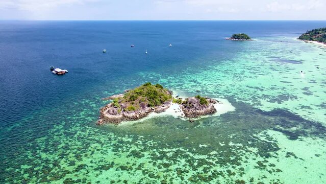 Kla Island in front of Koh Lipe Island Southern Thailand, turqouse colored ocean and white sandy beach with a kayak at Ko Lipe on a sunny day