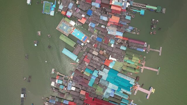 4K Aerial Footage of Koh Panyi (Panyee) Floating Village, Phang Nga Bay, Andaman Sea, Thailand - Featuring Longtail Boats, Limestone Cliffs and Floating Homes