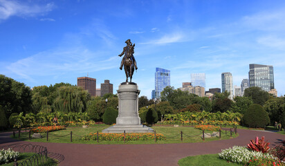 George Washington statue and Boston skyline in Public Garden, USA