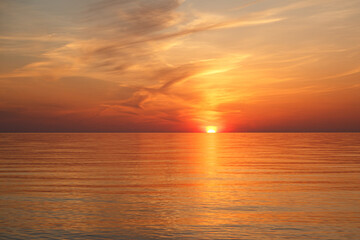 Beautiful Orange and Pink Sunset Over Calm Lake Water