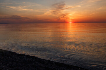Beautiful Orange and Pink Sunset Over Calm Lake Water