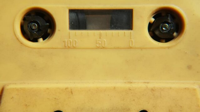 Old music audio player. Rotating tape on an old vintage cassette. Retro music concept.