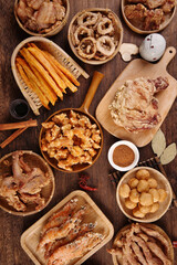Fried meat food, unhealthy diet, indoor wooden table background, various fried foods placed on the table