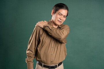 portrait of middle aged asian man posing on blue background