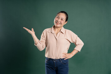 Gangang middle-aged Asian female portrait posing on blue background