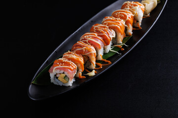 Salmon Sushi roll Japanese food isolated in black background
