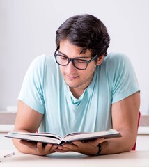 Young handsome student preparing for school exams