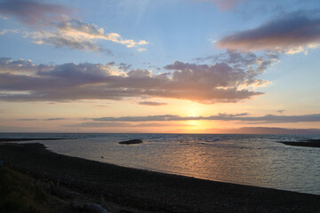 Beautiful sunset with blue sky, clouds and the beach.