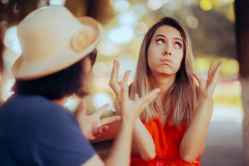 Unhappy Woman Arguing with Her mother in the Park. Disrespectful daughter finding the conversation with her mom boring 
