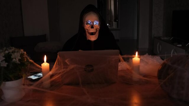 terribly scary character of death, calls with a bone hand, dark background. Happy Halloween night party invitation.