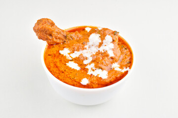 Creamy butter chicken in bowl isolated on white background