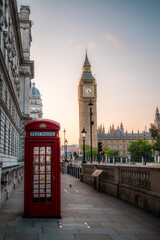 Traditional red british telephone box with Big Ben at sunrise London, UK. Travelling concept. London landmarks