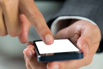 Digital png photo of businessman holding smartphone with copy space on transparent background