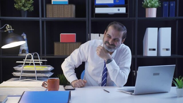 Businessman slyly laughing thinking cunning ideas.