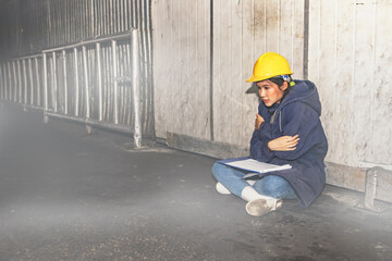 Accident female worker worker wearing sweater stuck inside the warehouse freezer food processing warehouse with negative temperatures did not leave room sitting anxiously next to the door for help.