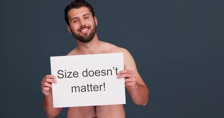 Message, self love and pride with man and poster in studio for wellness, confidence and acceptance. Health, body positivity and promotion with portrait of person on dark background for empowerment