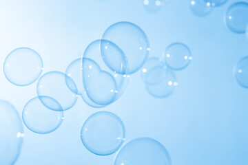 Refreshing of Soap suds, Bubbles Water. Beautiful Transparent Blue Soap Bubbles Floating in The Air. Abstract Blurred Background, Blue Textured, Celebration Festive Backdrop.