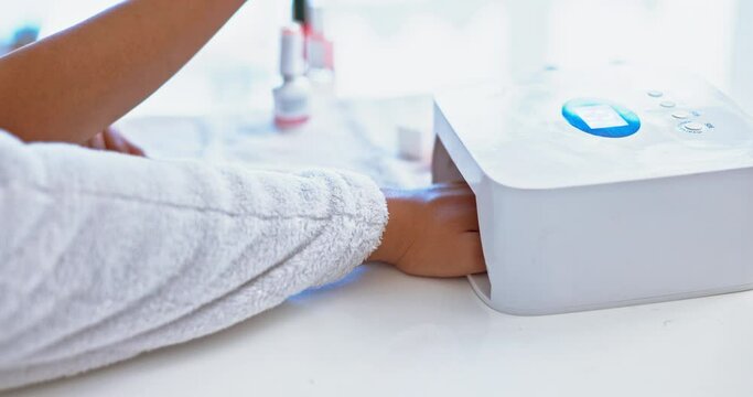 Hands on woman at spa, nail polish and uv light with technician for beauty, luxury grooming and cosmetics. Professional led manicure service, machine and girl at salon for wellness and color on nails