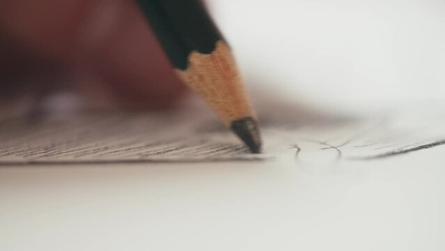 macro shot of a pencil sketching shadows on a drawing