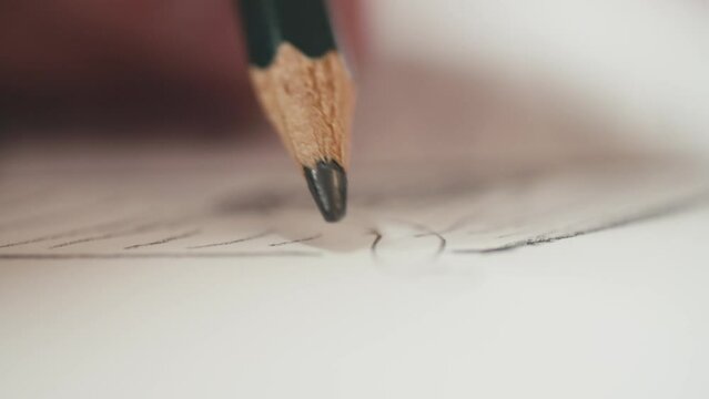 camera following a pencil drawing on white paper