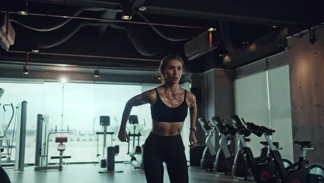 Asian woman jumping on plyo box for exercises at a fitness gym. Sports training, and fitness concepts.