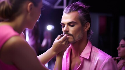 Naklejka premium Portrait of a male makeup artist backstage at a fashion show transforming models into living works of art