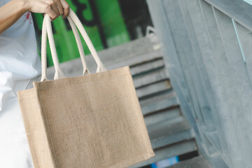 Woman holding jute bag or sack bag. Reusable shopping bag. Plastic free. Eco friendly concept. Sack bag for reusable shopping lifestyles, ecology business concept.