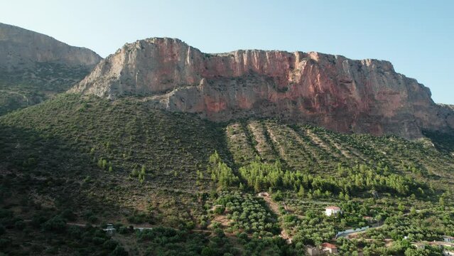 Panoramic establish shot of rocky cliff mountain in leonidio greece, awaiting climbers to challenge routes