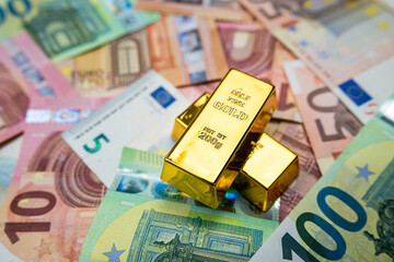 Stack of gold bars on euro money. Finance concept.
