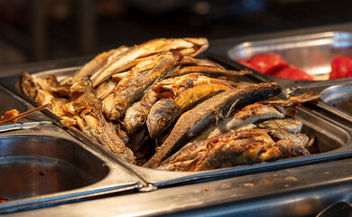 Fried fish on a tray in a restaurant