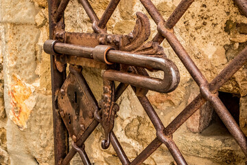 Cast iron rusty old door metallic handle, Italy, selective shallow depth of field