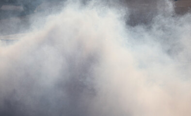 Smoke from under the wheels of the car. Background