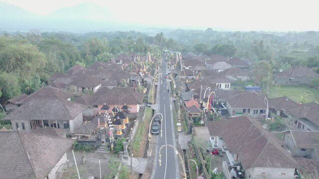 Aerial dolly shot through traditional residential neighborhood in small village in Tabanan, Bali, Indonesia