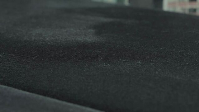 Applying a special solution for cleaning sofa upholstery, close-up. Dry cleaning of upholstered furniture. Copy space for text