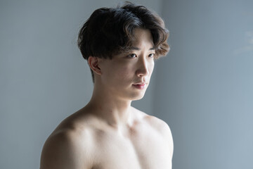 Close-up of a man's face with muscles like David's sculpture