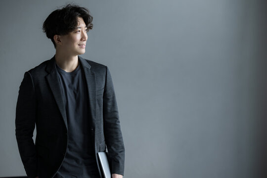 Handsome Japanese businessman in jacket, profile.