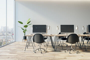 Simple coworking office interior with computer monitors, window and city view and furniture. 3D Rendering.
