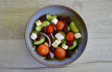 A bowl of Greek salad on the table