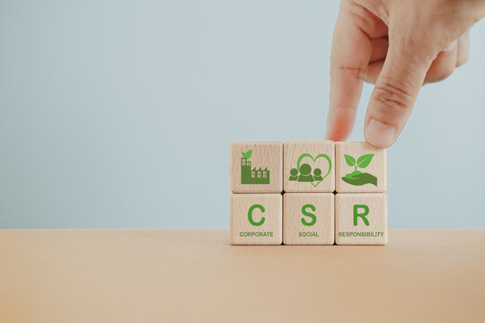 CSR, Corporate Social Responsibility, sustainability or sustainable development concept. Hand completed wooden cubes with CSR text and icons