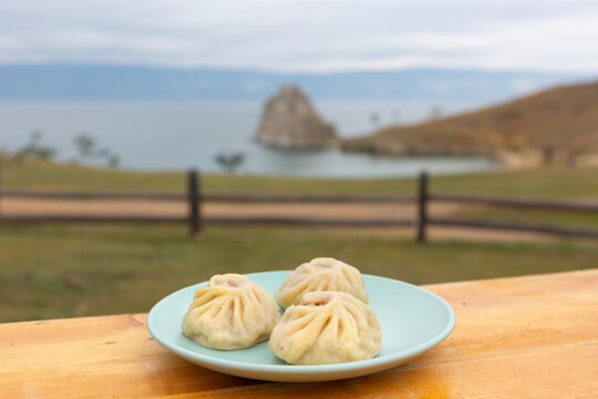 National Buryat Food on the Table on Blur Lake Baikal Background