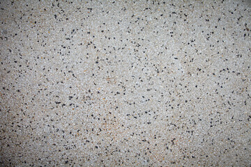 Obraz premium Cement mixed small gravel stone wall or floor texture background,The Dust Texture. Abstract dense splash texture. Random pebble gravel oval elements seamless pattern.