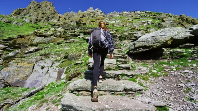 Young woman walking up endless stairs in Ireland