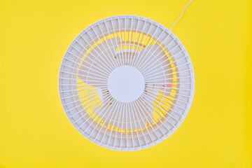 Air circulator on yellow background.