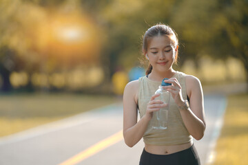 Beautiful Asian woman drinking water from the bottle water after concept healthy lifestyle and sport.
