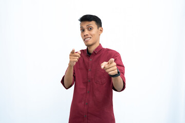 Asian man, businessman or student concept wearing red casual clothes poses pointing at you. Isolated white background.