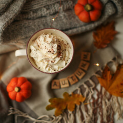 Autumn composition - Pumpkin Spice Latte, maple leaves and pumpkins on black background, creative flat lay, top view, copy space. 