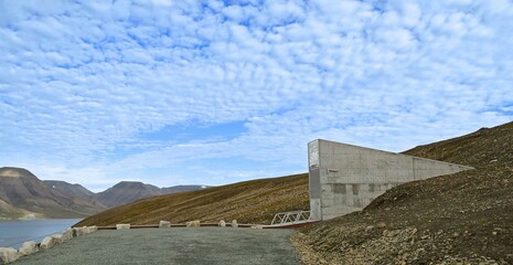 the exterior of the svalbard global seed vault on a rocky mountainside above adventfjorden bay and longyearbyen, spitsbergen, svalbard