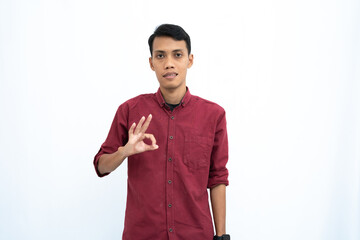 asian man, businessman or student concept wearing red casual shirt showing thumbs up that agree, okay. Isolated white background.